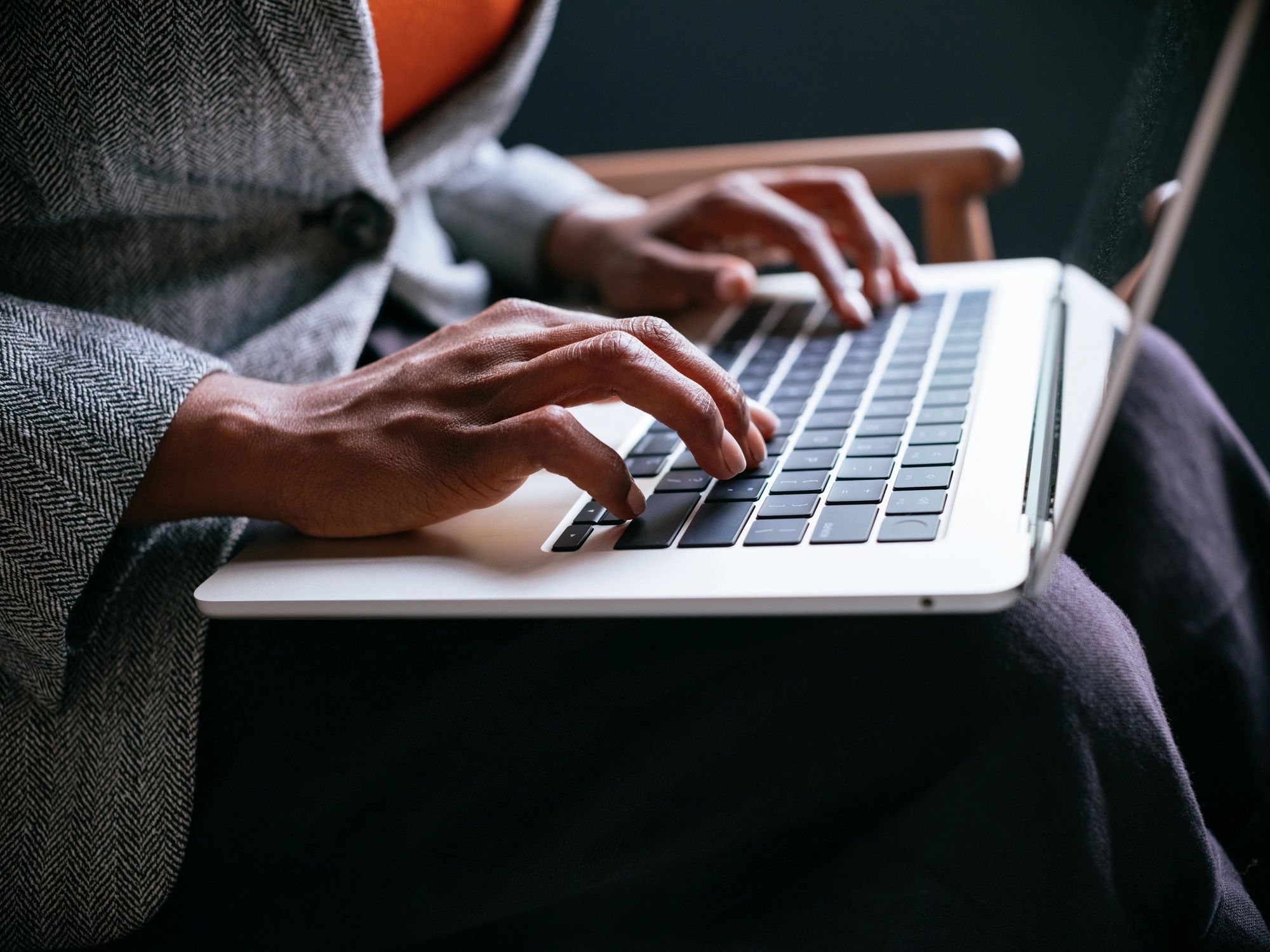 Professional typing on a laptop in a focused work setting