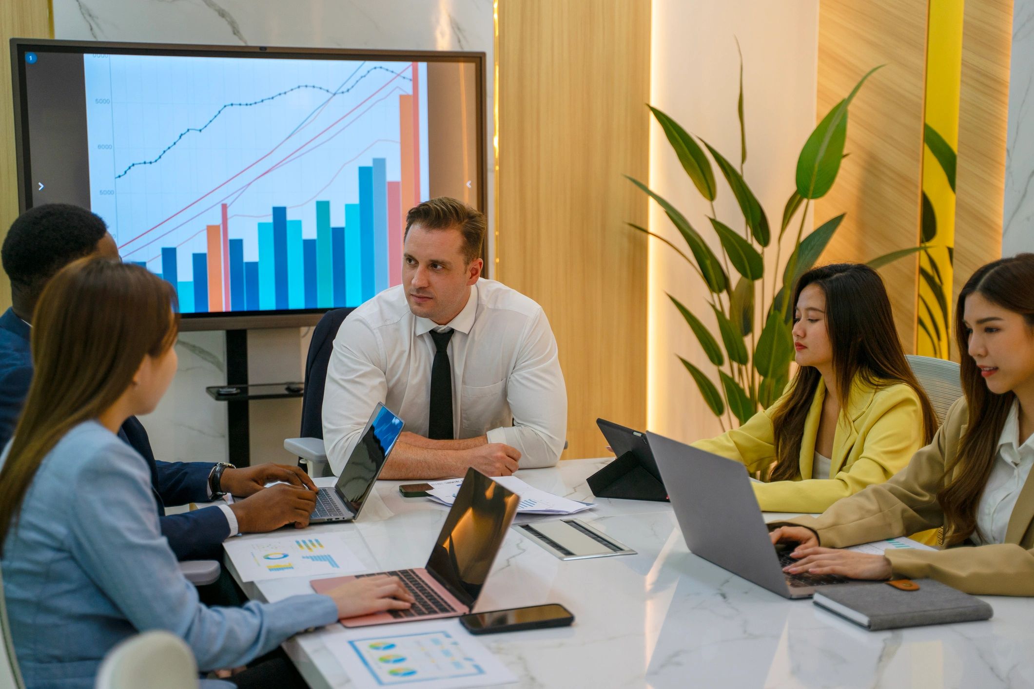 Office team meeting around a laptop