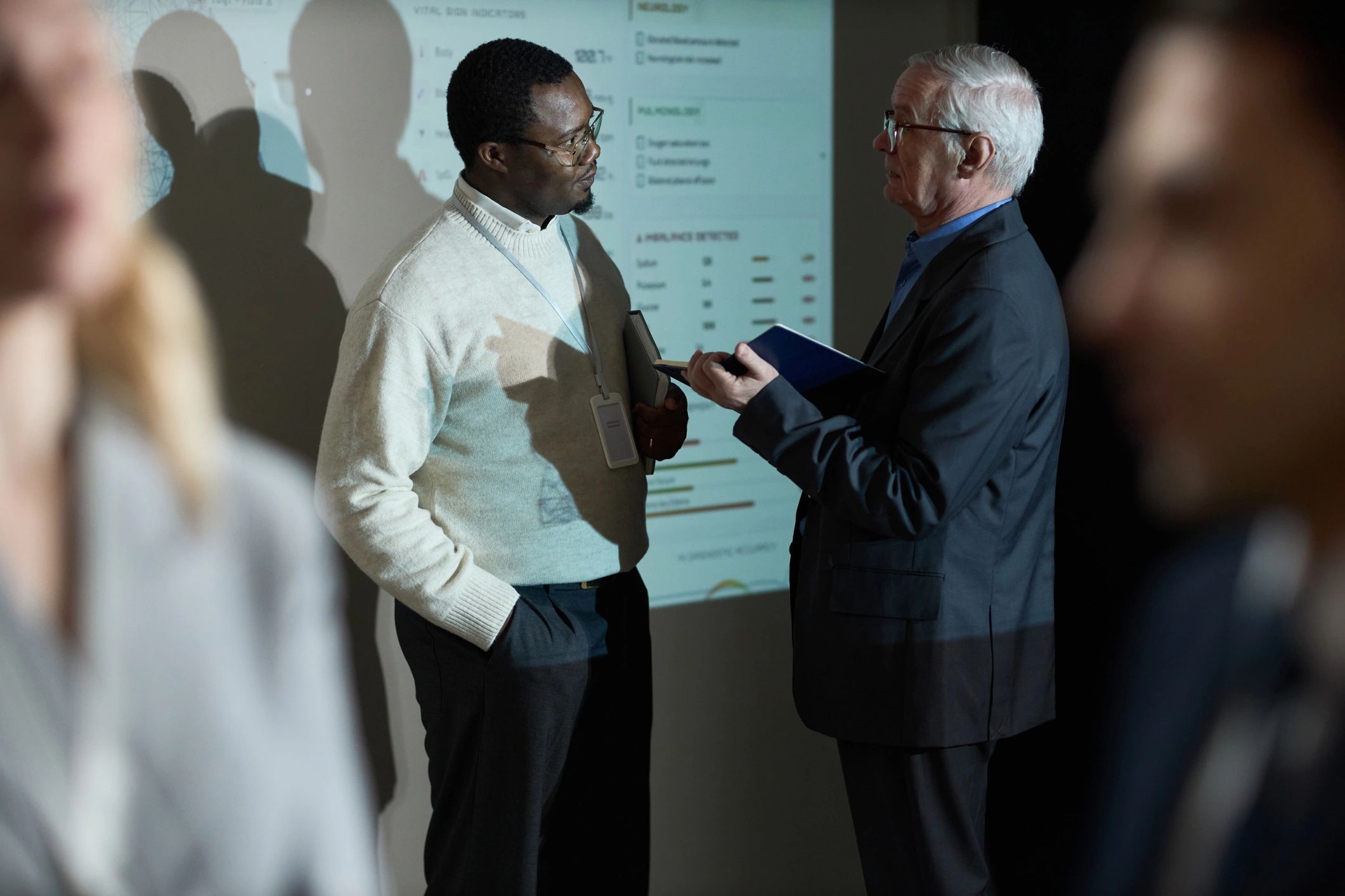 Two professionals reviewing data together during a training discussion